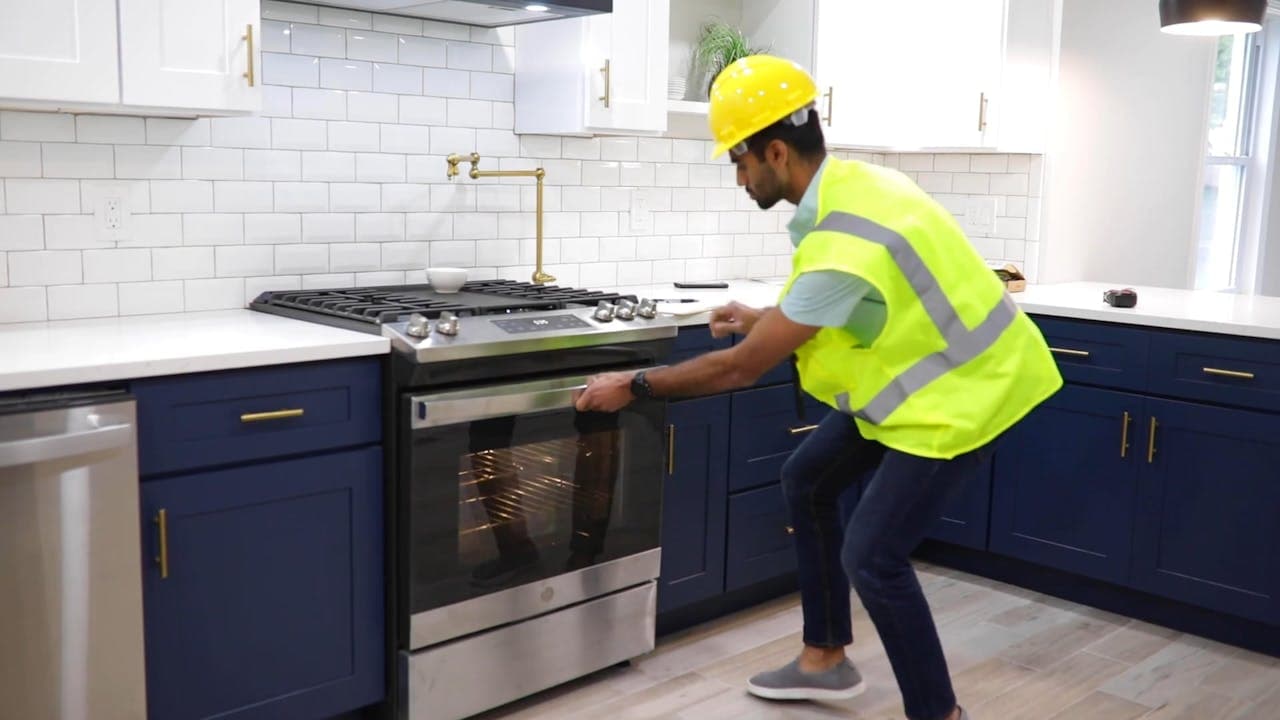 Appliance repair technician servicing a gas range